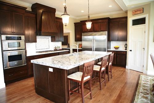 Cambria Bellingham Countertop and Cambria Bellingham Island Top with Dark Chestnut Stained Cherry Cabinets, Red Oak Flooring, Stainless Steel Appliance and White Carrara Marble Subway Tiles